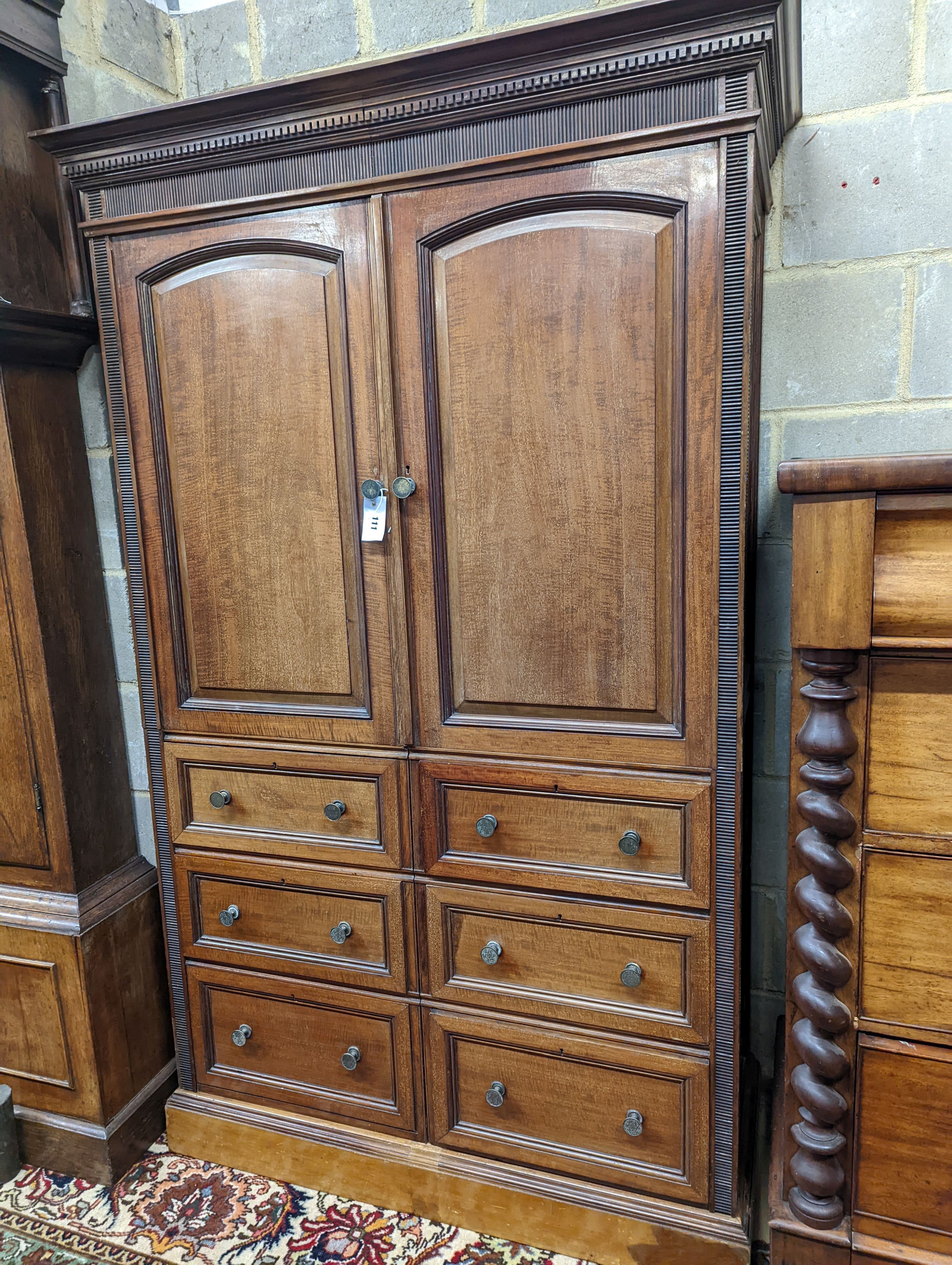 A late Victorian mahogany press cupboard (altered), width 114cm, height 182cm